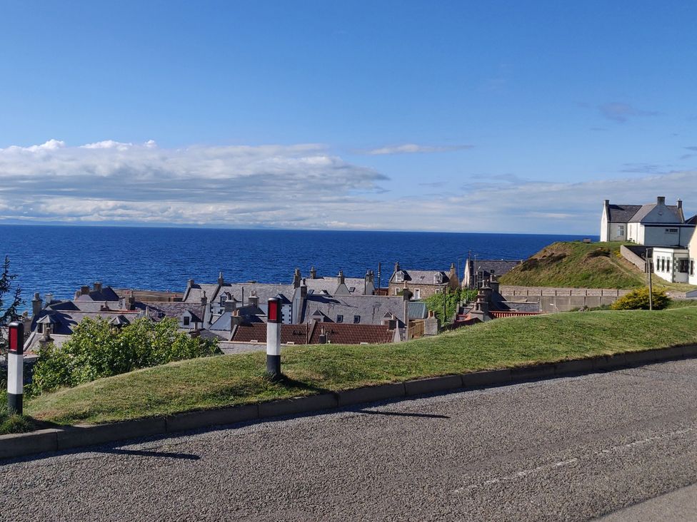 A view of houses near the ocean with a clear sky at a location