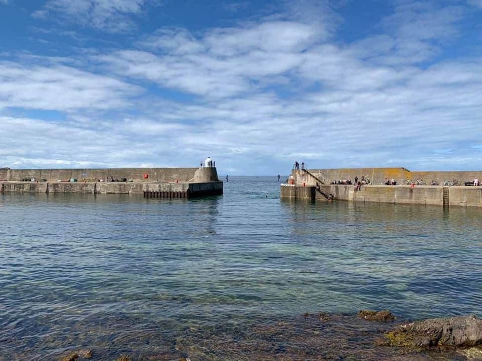 A pier with people at the coast