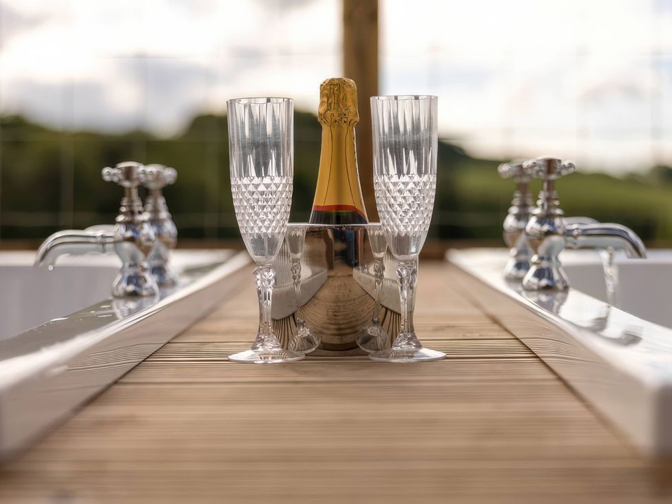 A table with champagne and glasses at an outdoor area