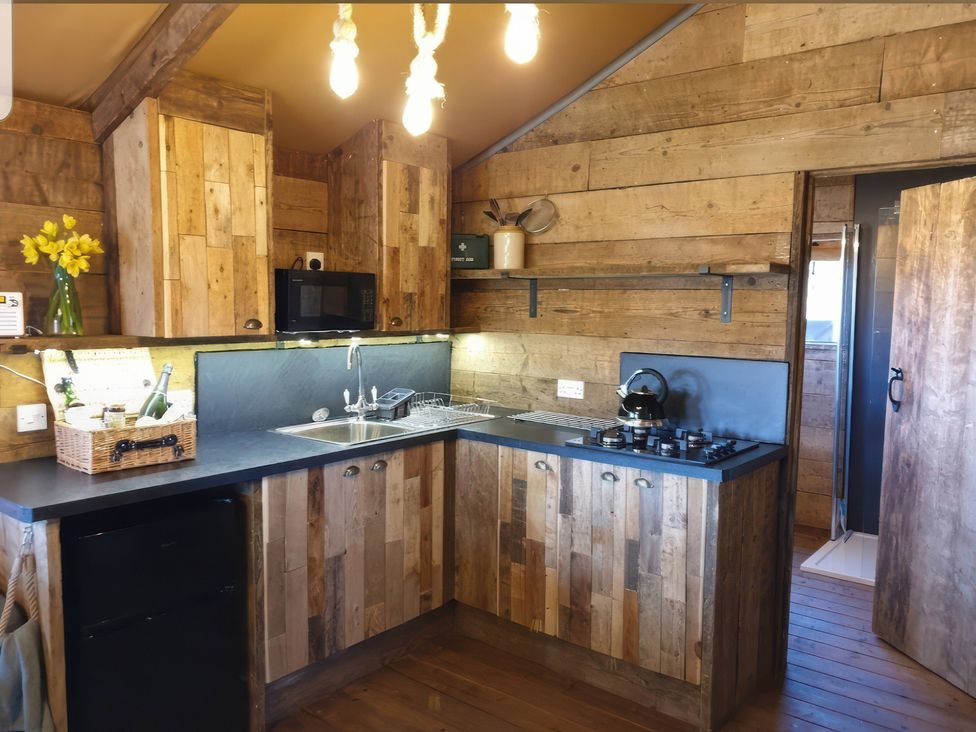 A kitchen with wooden cabinets and appliances at 