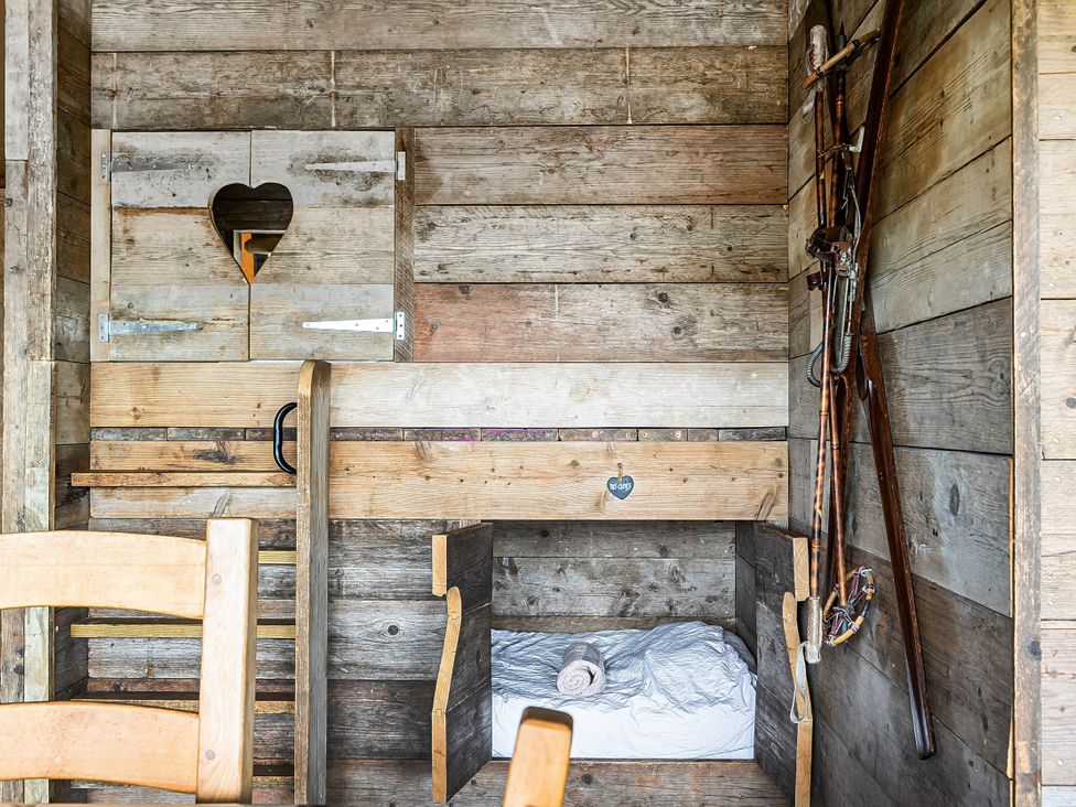 A sleeping area with wooden walls and a bunk bed at Luxury Safari Lodge Sleeps 4/6 Deer Park Dogs Ok Zeal Monachorum near Bow