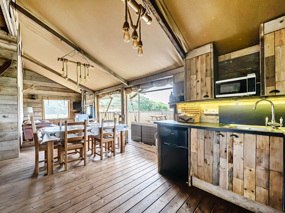 A dining area with a table and chairs at Luxury Safari Lodge Sleeps 4/6 Deer Park Dogs Ok near Zeal Monachorum
