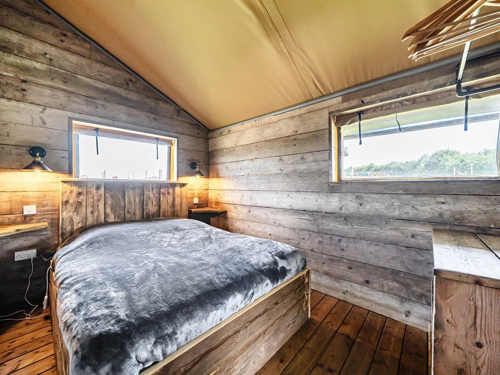 A bedroom with a bed and windows at Luxury Safari Lodge Sleeps 4/6 Deer Park Dogs Ok Zeal Monachorum near Bow