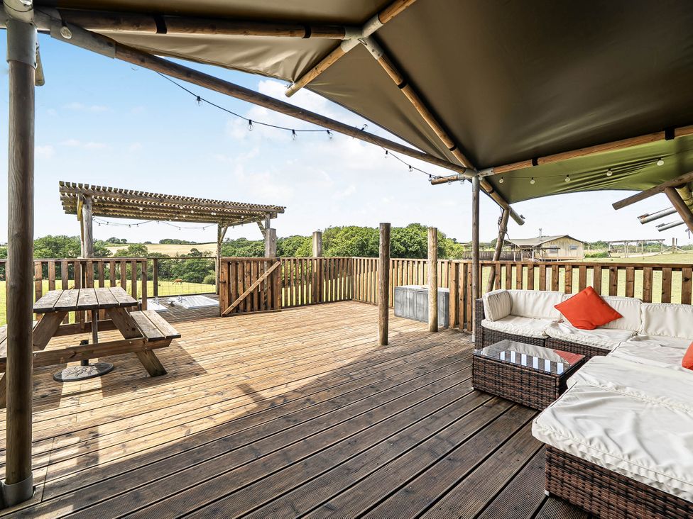 An outdoor deck with seating and a table at Luxury Safari Lodge Sleeps 4/6 Deer Park Dogs Ok Zeal Monachorum near Bow