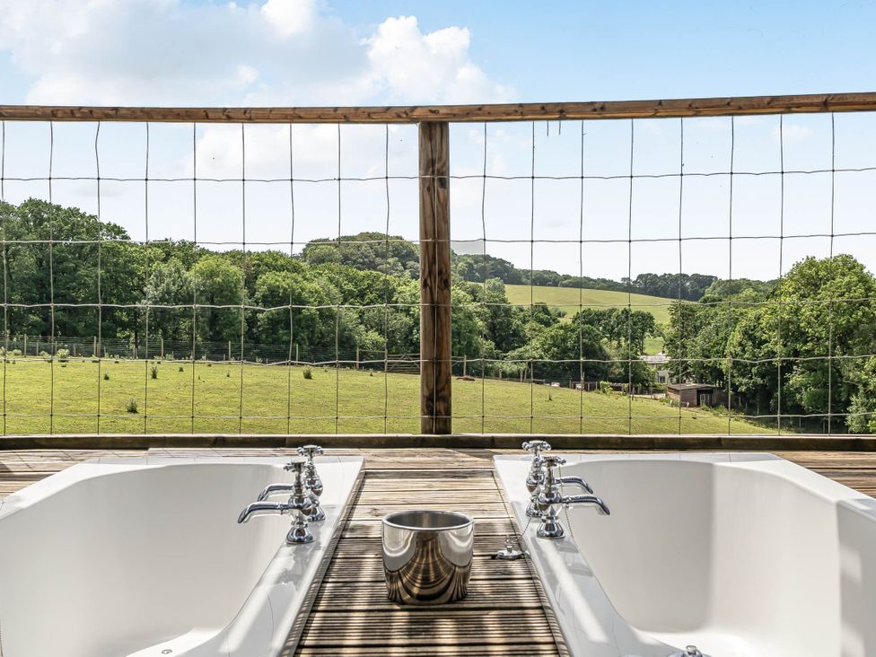 A bathroom with bathtubs and a view of the outdoor area at Luxury Safari Lodge Sleeps 4/6 Deer Park Dogs Ok Zeal Monachorum near Bow