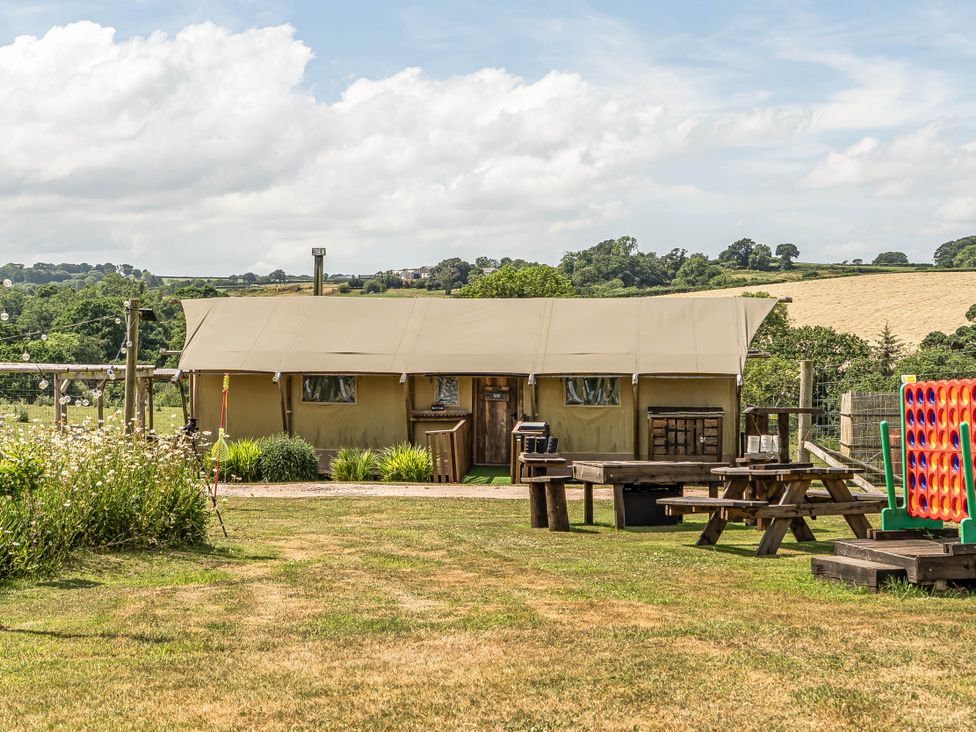 A tent with picnic tables and garden games at Luxury Safari Lodge Sleeps 4/6 Deer Park Dogs Ok Zeal Monachorum near Bow