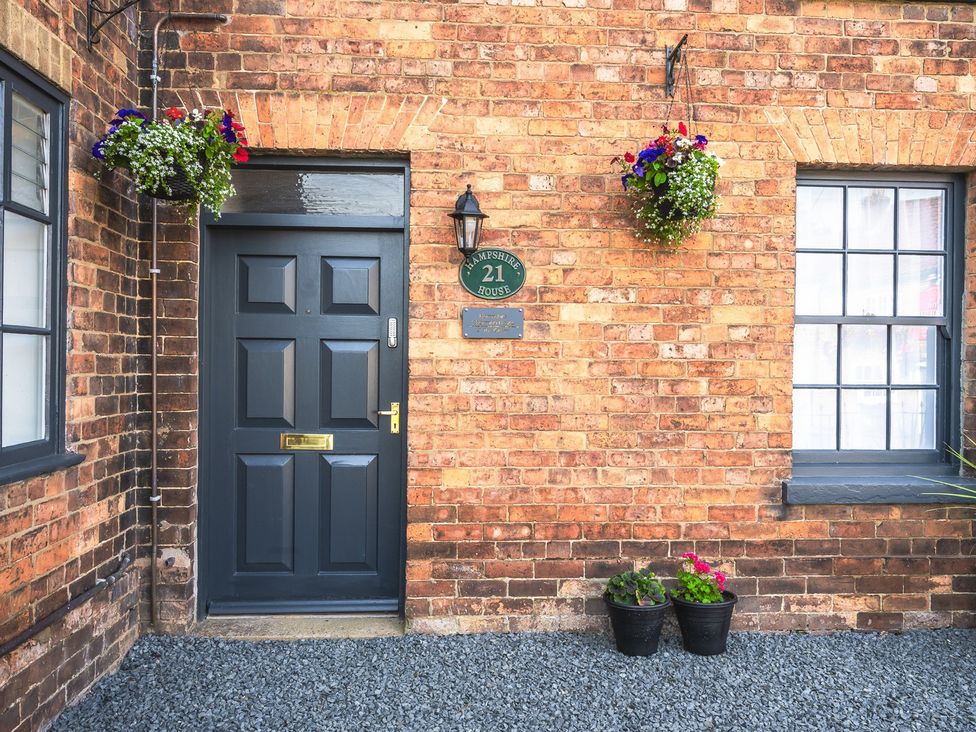 An entrance door with a house number at Hampshire House in a residential area