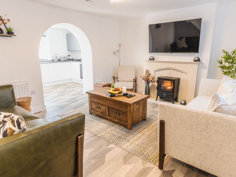 A living room with a coffee table and a television at a property in an unspecified location