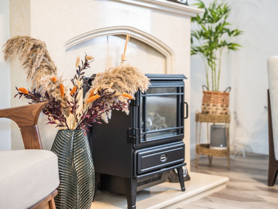 A living room with a fireplace and decorative vase at 