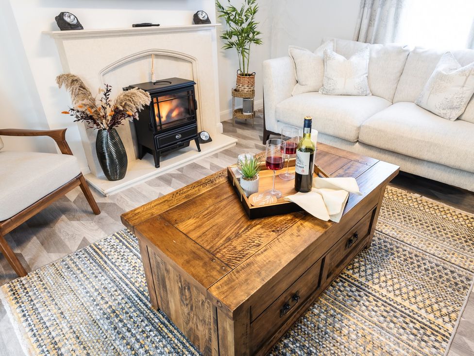 A living room with a coffee table and a fireplace at a property