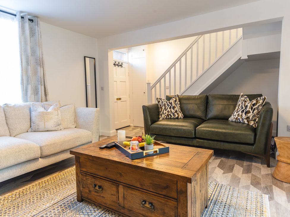 A living room with a sofa and coffee table at The Old Barn in Manchester