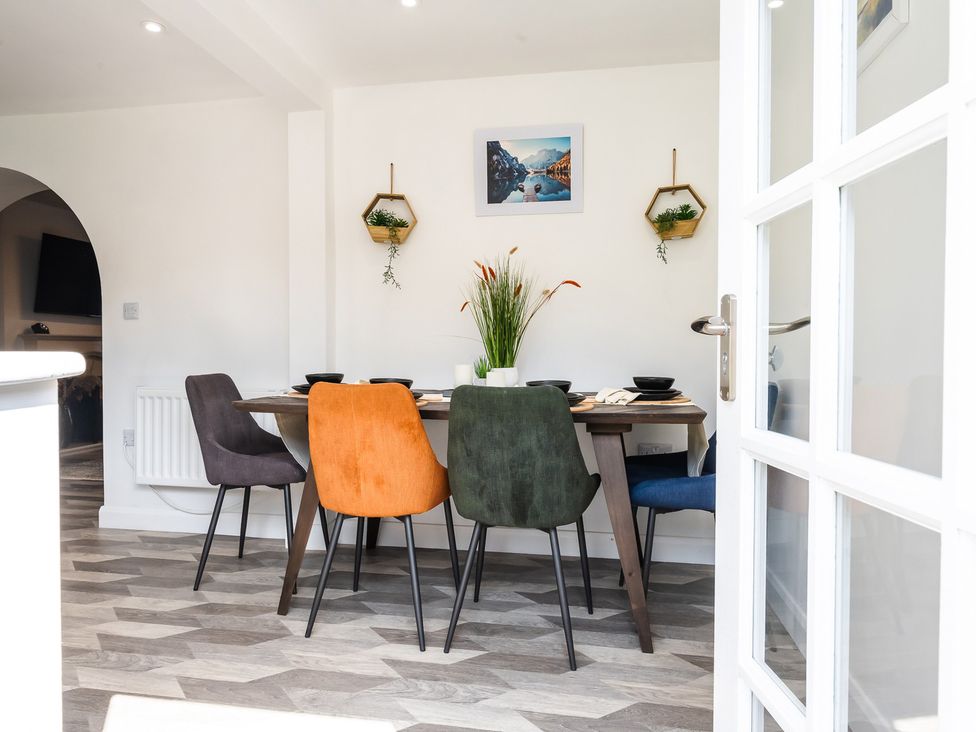 A dining room with a table and chairs at The Old Barn in Manchester