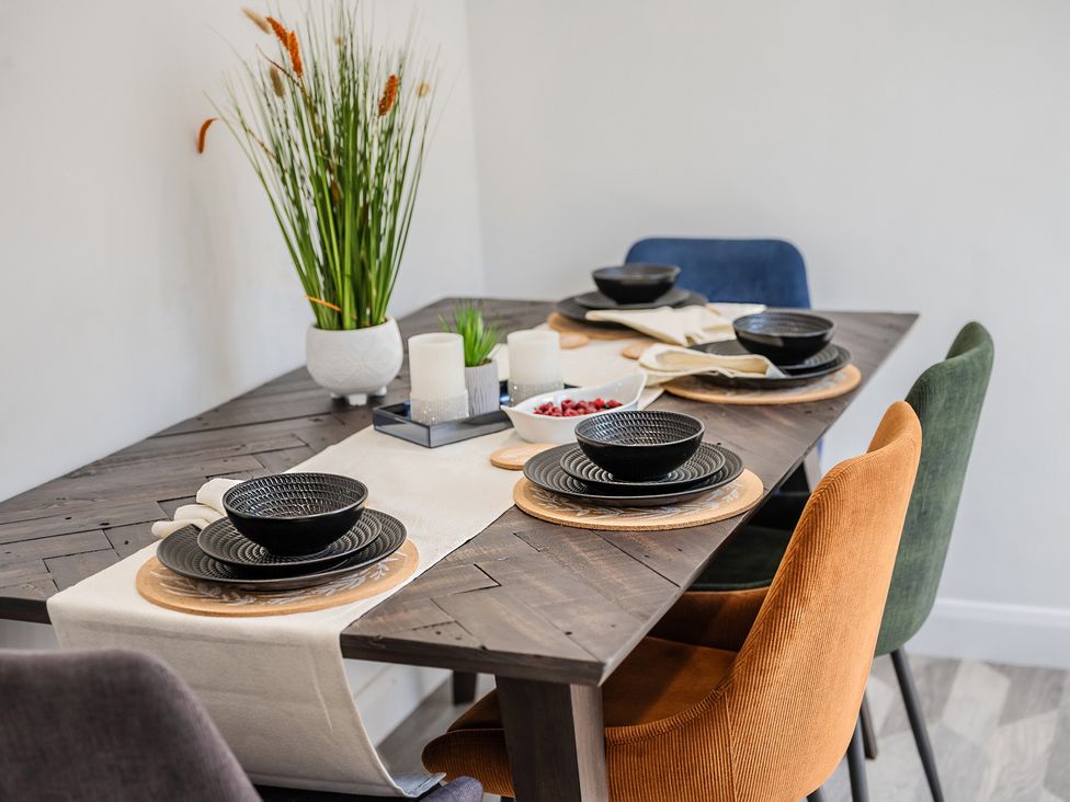 A dining table set with plates and bowls at the property in location