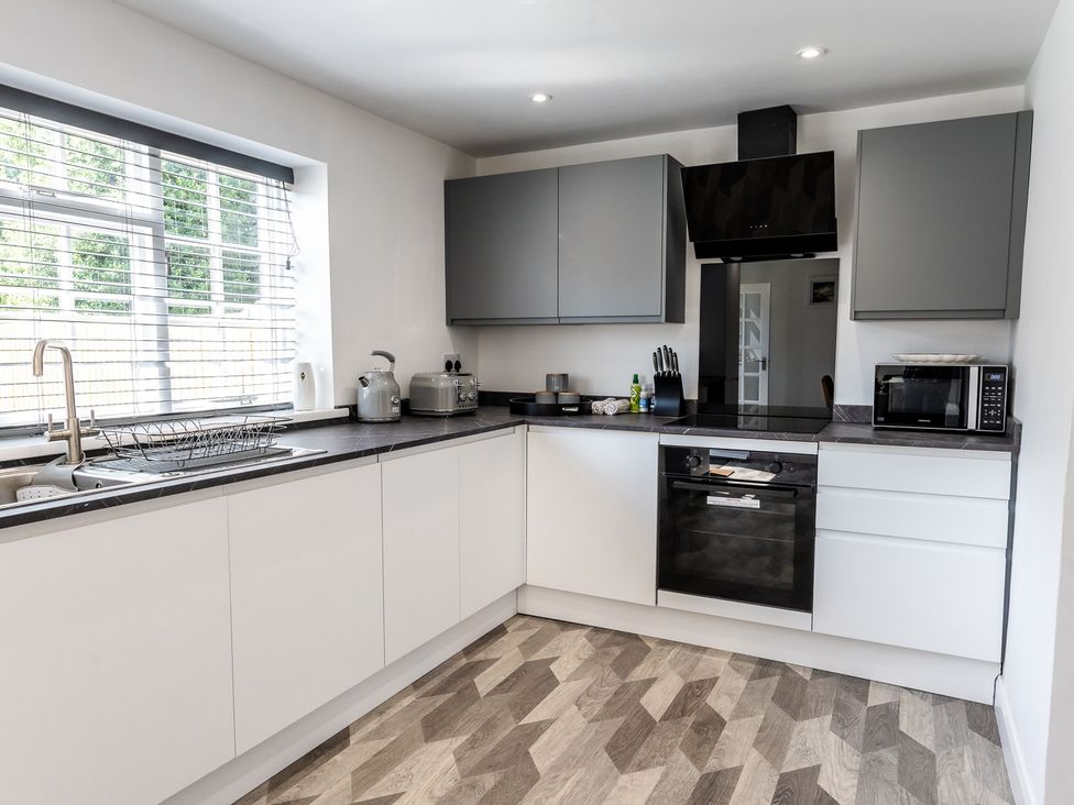 A kitchen with countertop and appliances at The Old Barn in Manchester
