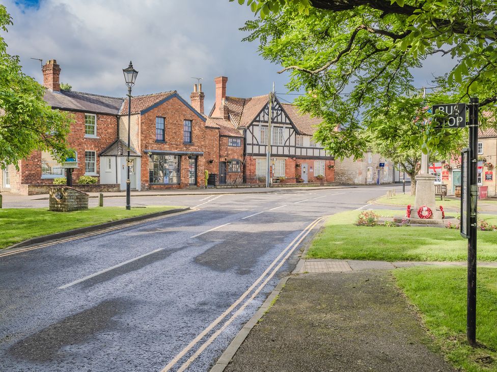 A street view with buildings and a lamppost at The Old Barn in Manchester