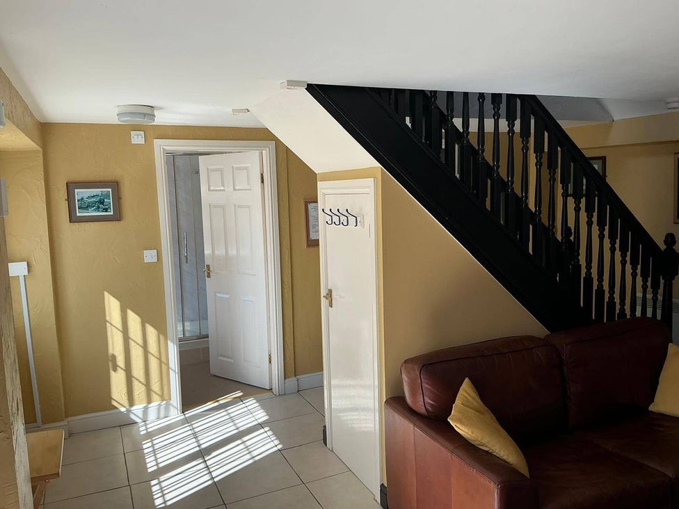 An entryway with a staircase and a sofa at the property in the location