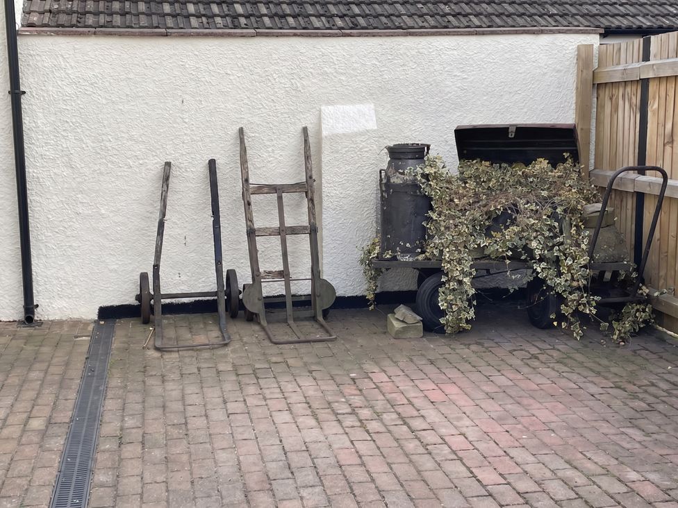 Outdoor area with carts and a milk churn at the property