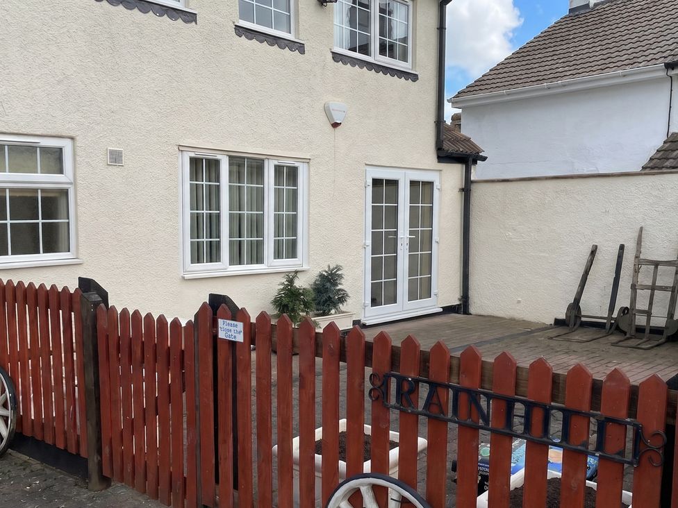 An outdoor area with a fenced entrance and doors at the property