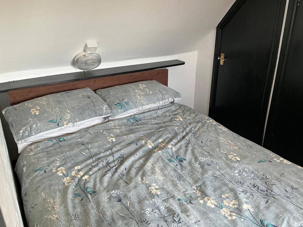 A bedroom with a bed and pillows at the property