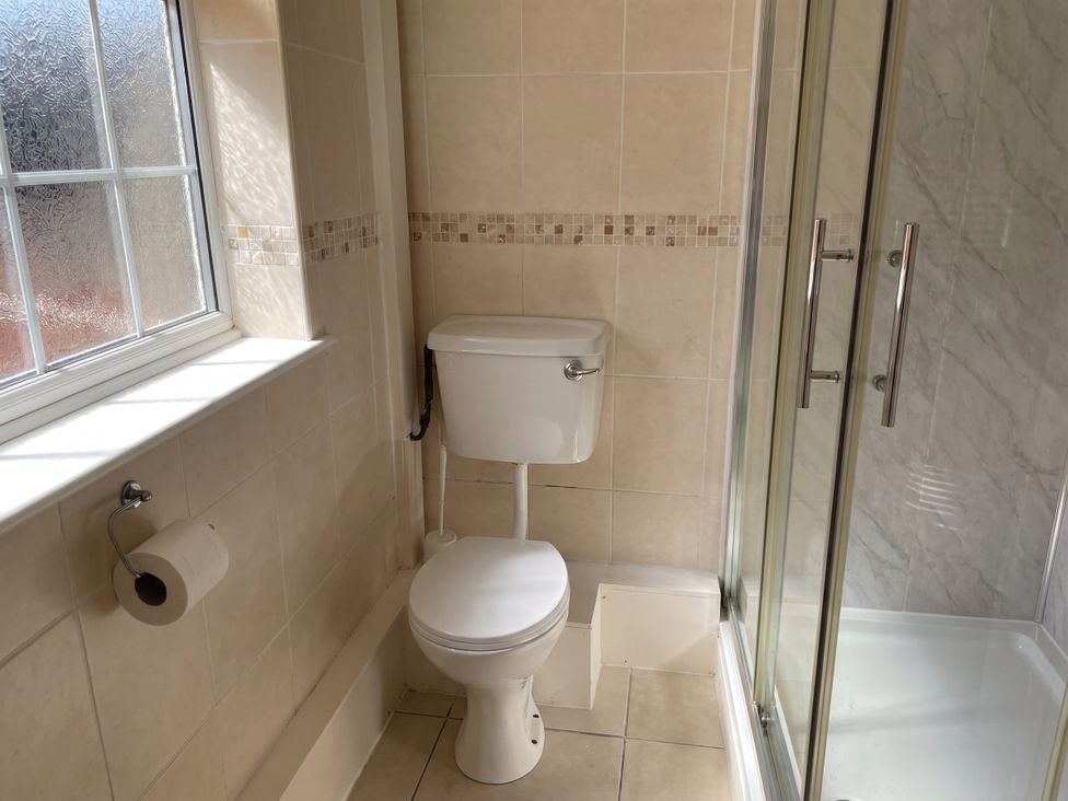 A bathroom with a toilet and shower at The Old Barn in Manchester