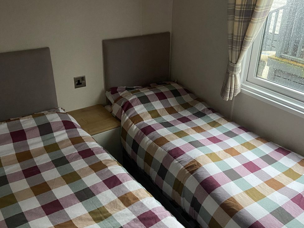 A bedroom with two single beds and a window at 