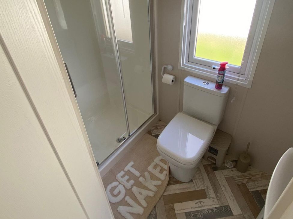 A bathroom with a shower and toilet at 