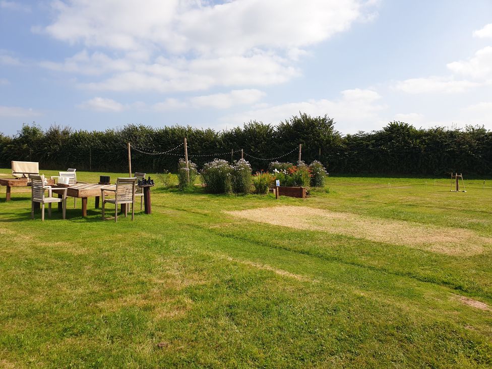 An outdoor area with furniture and flower beds at the property