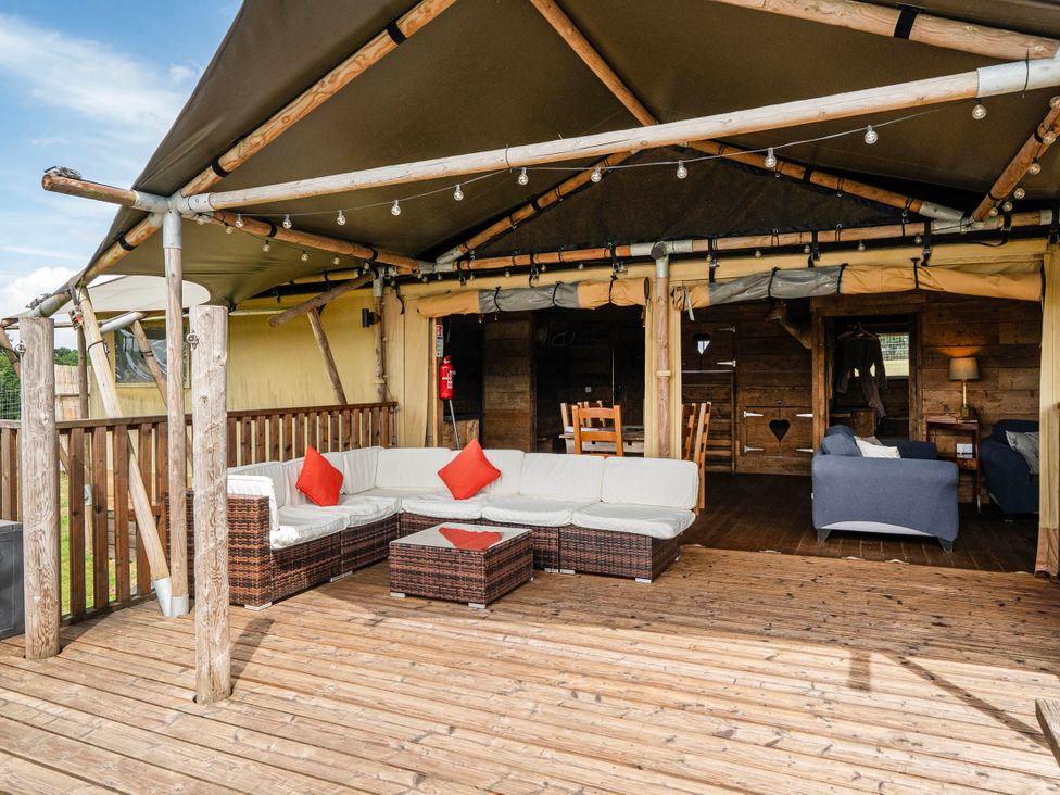An outdoor seating area with a sofa and coffee table at Luxury Safari Lodge Sleeps 4/6 Deer Park Dogs Ok Zeal Monachorum near Bow