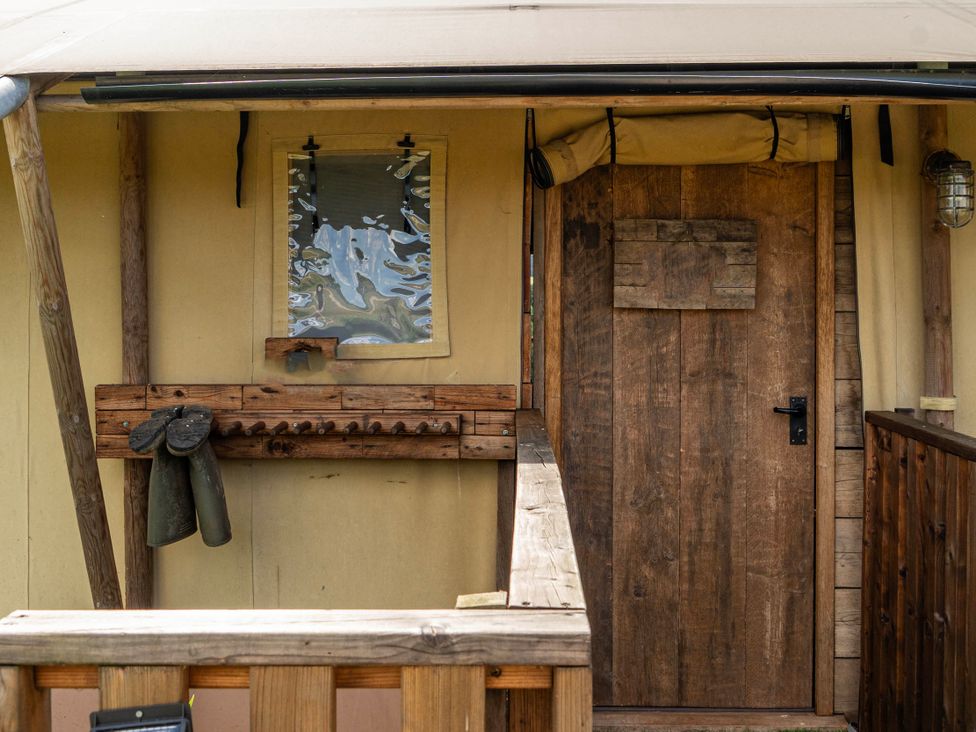 An entryway with a wooden door and coat rack at Luxury Safari Lodge Sleeps 4/6 Deer Park Dogs Ok Zeal Monachorum near Bow