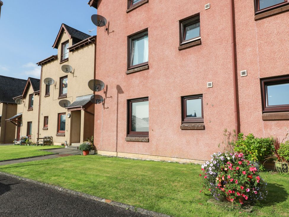 An outdoor view of an apartment building with satellite dishes and flower pots at No.31 Craigard Road