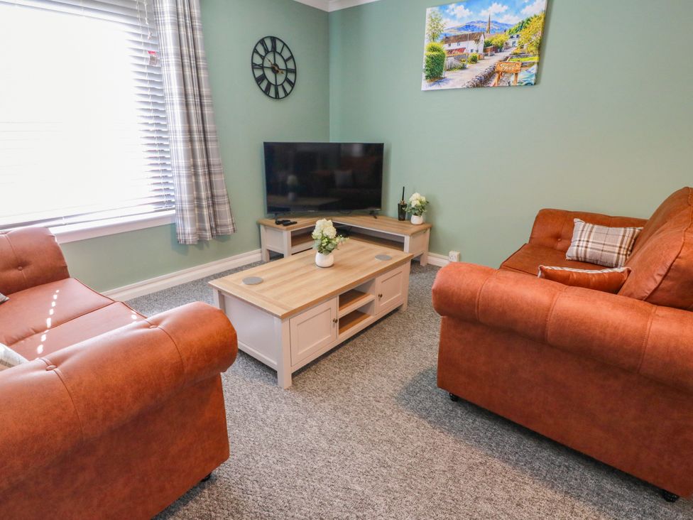 A living room with a television and sofas at No.31 Craigard Road