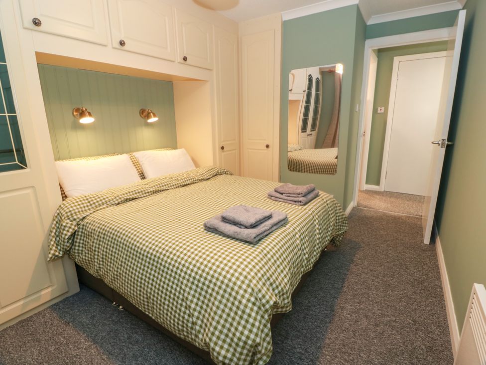 A bedroom with a bed and towels at No.31 Craigard Road