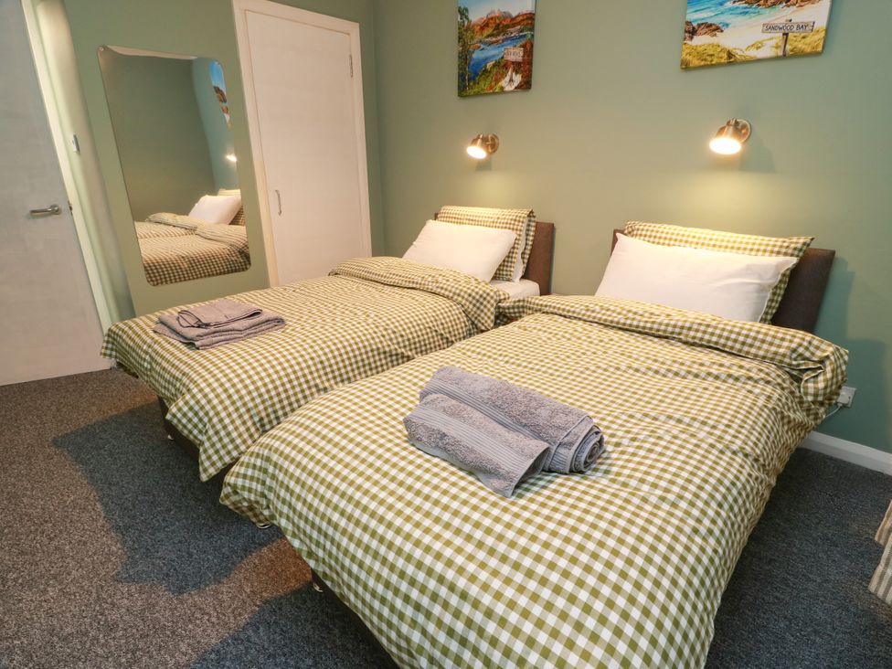 A bedroom with two single beds and a mirror at No.31 Craigard Road 