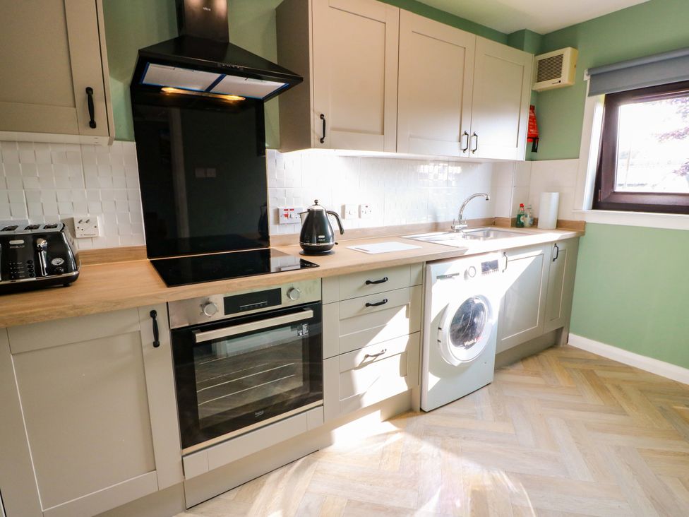 A kitchen with cabinets and appliances at No.31 Craigard Road