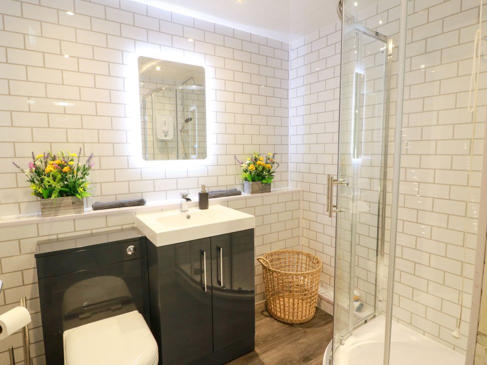 A bathroom with a shower and sink at No.31 Craigard Road