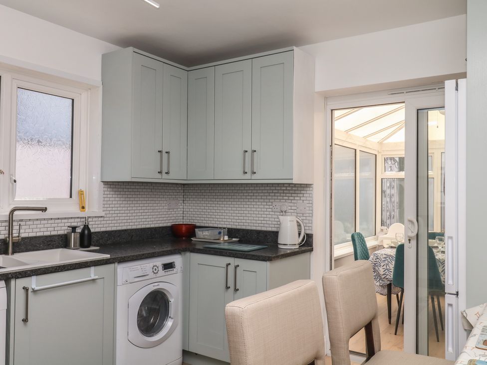 A kitchen with cabinets and appliances at 3 Heath Park in Brixham