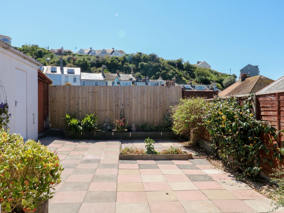 A garden with paving stones, fence and plants at 3 Heath Park in Brixham