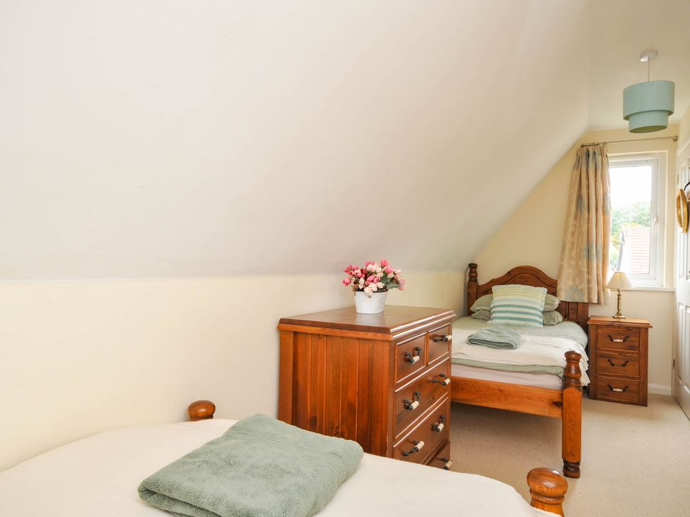 A bedroom with two beds and a dresser at No.122 Hengar Holiday Park near St Tudy