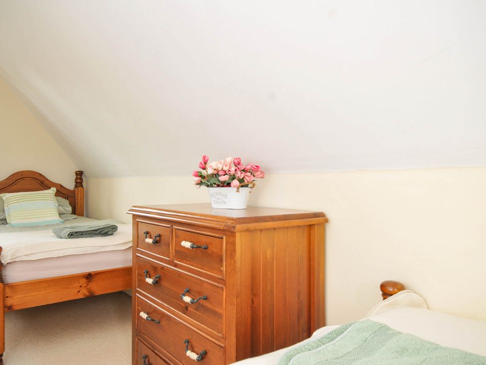 A bedroom with two beds and a chest of drawers at No.122 Hengar Holiday Park near St Tudy