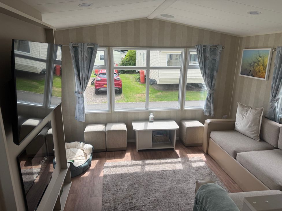 A living room with a sofa and coffee table at Haggerston Castle Lakeside East 76, Berwick-upon-Tweed