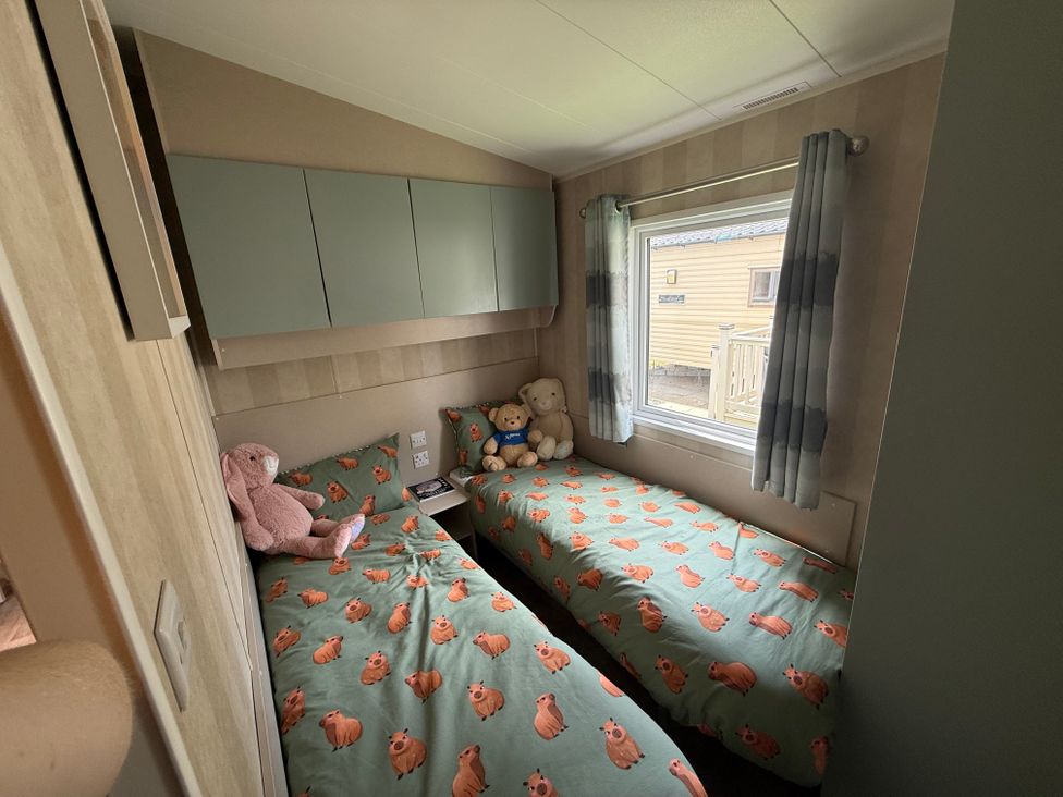 A bedroom with two beds and stuffed toys at Haggerston Castle Lakeside East 76 Berwick-upon-Tweed