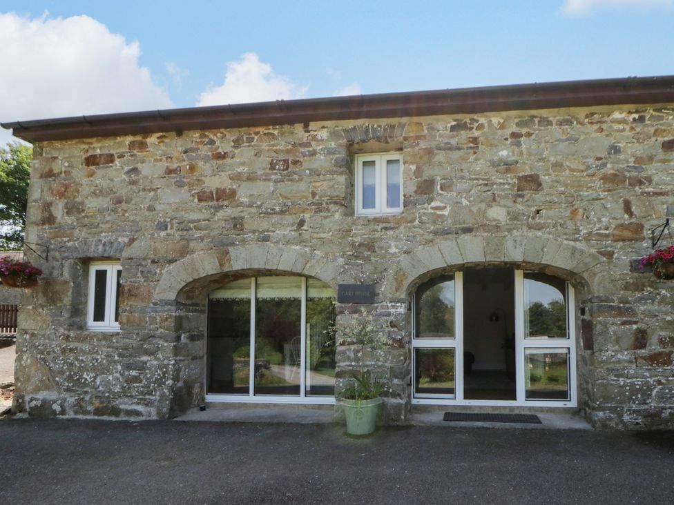 A stone building exterior with windows and a door at The Cart House in Pontsian