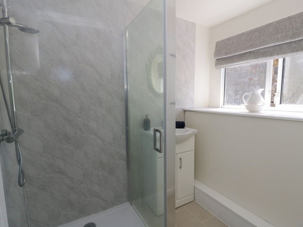 A bathroom with a shower and a sink at The Cart House in Pontsian