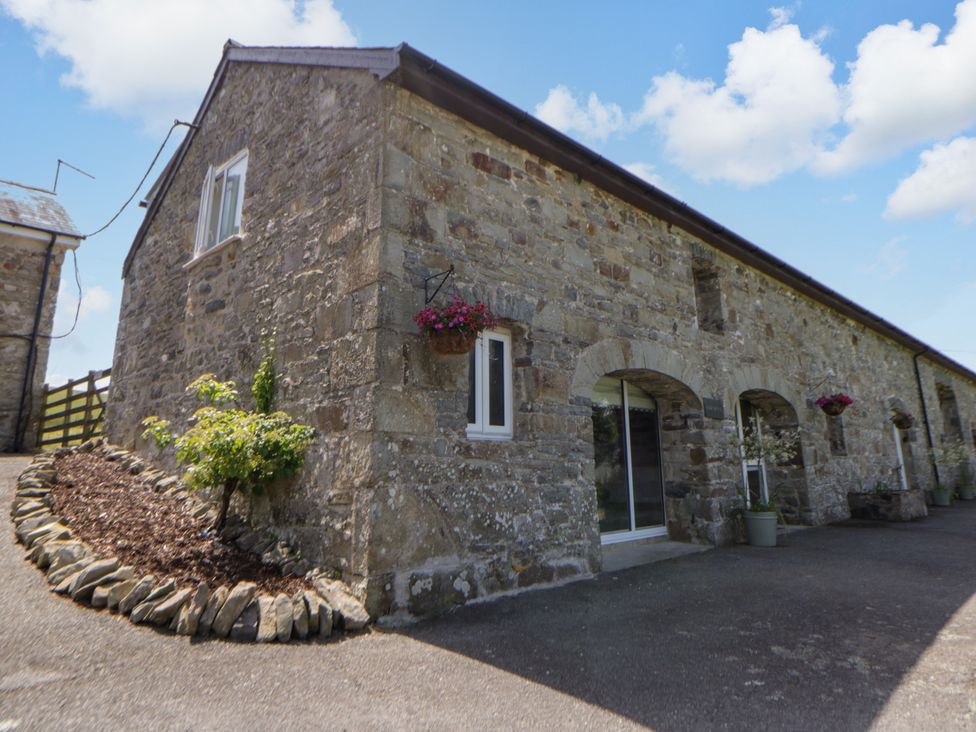 A stone building with windows and a door at The Cart House in Pontsian