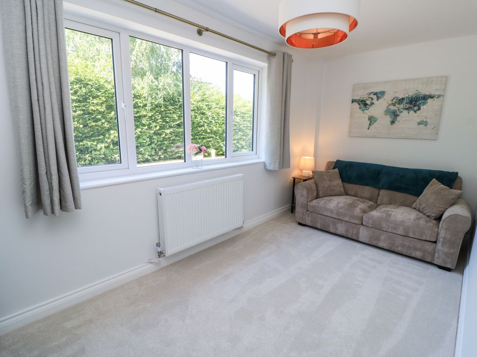 A living room with a sofa and a window at Cern-Wyn in Chippenham