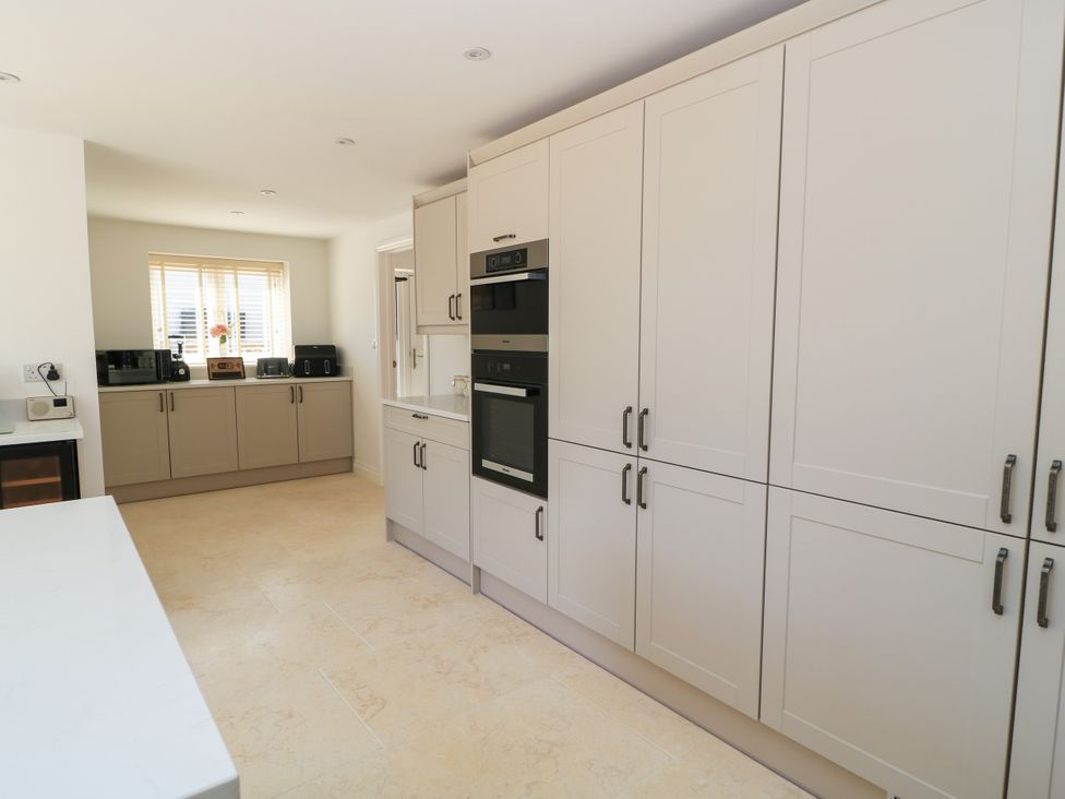 A kitchen with cabinets, oven and appliances at Cern-Wyn in Chippenham