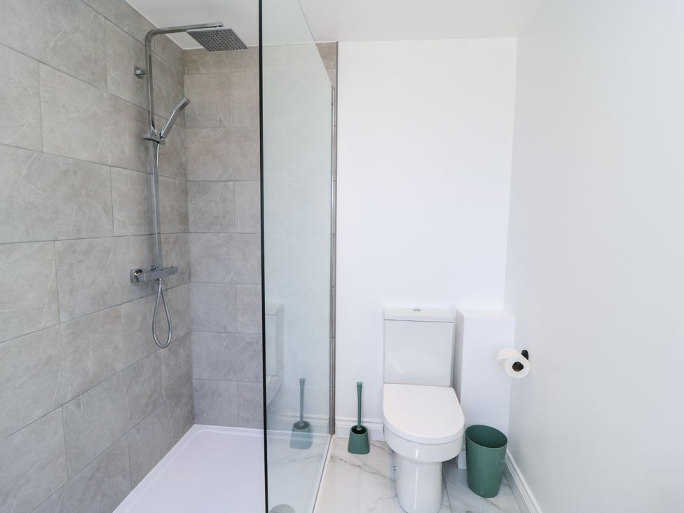 A bathroom with a shower and toilet at Cern-Wyn in Chippenham