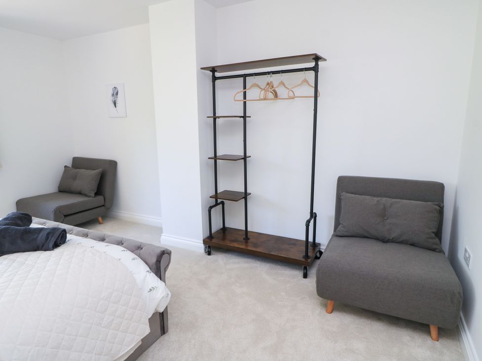 A bedroom with a bed and seating at Cern-Wyn in Chippenham