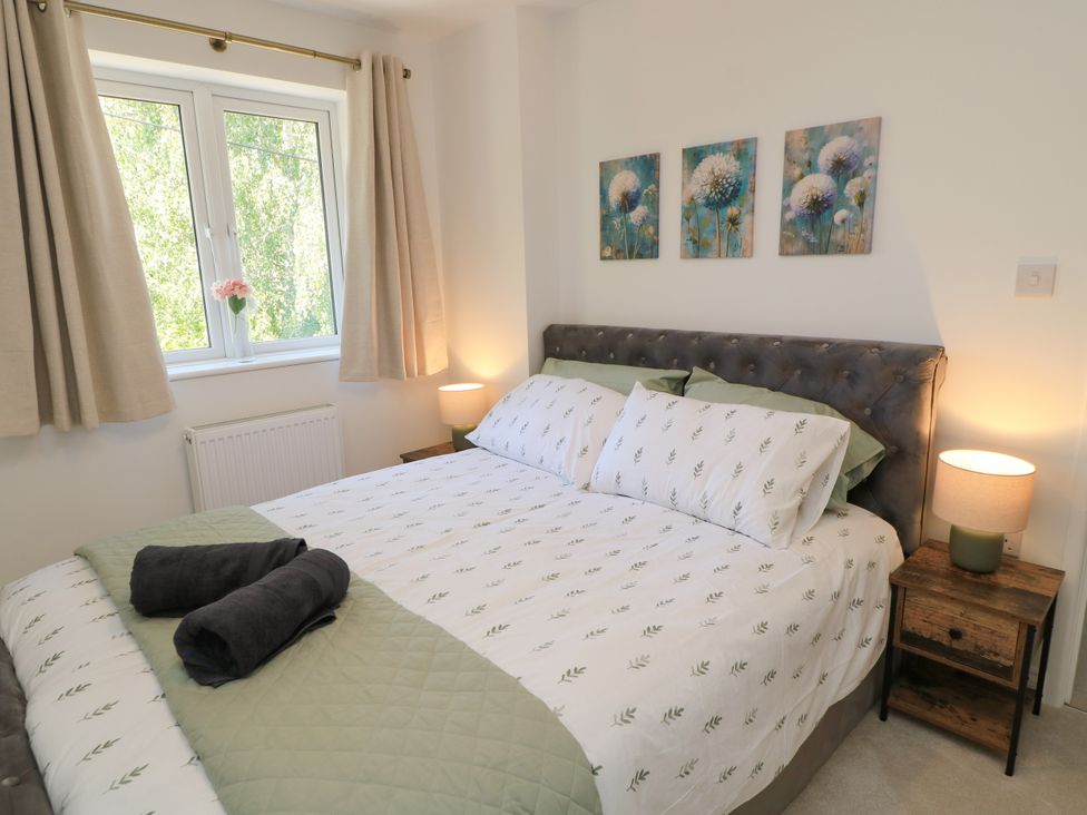 A bedroom with a bed and window at Cern-Wyn in Chippenham