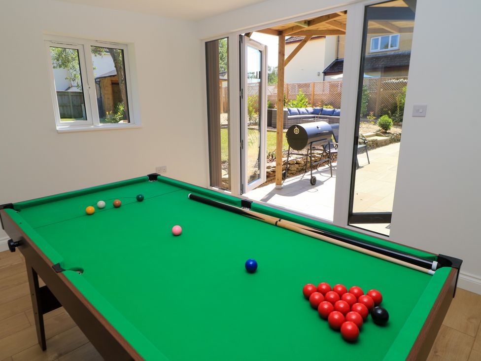 A games room with a pool table and access to outdoor area at Cern-Wyn in Chippenham